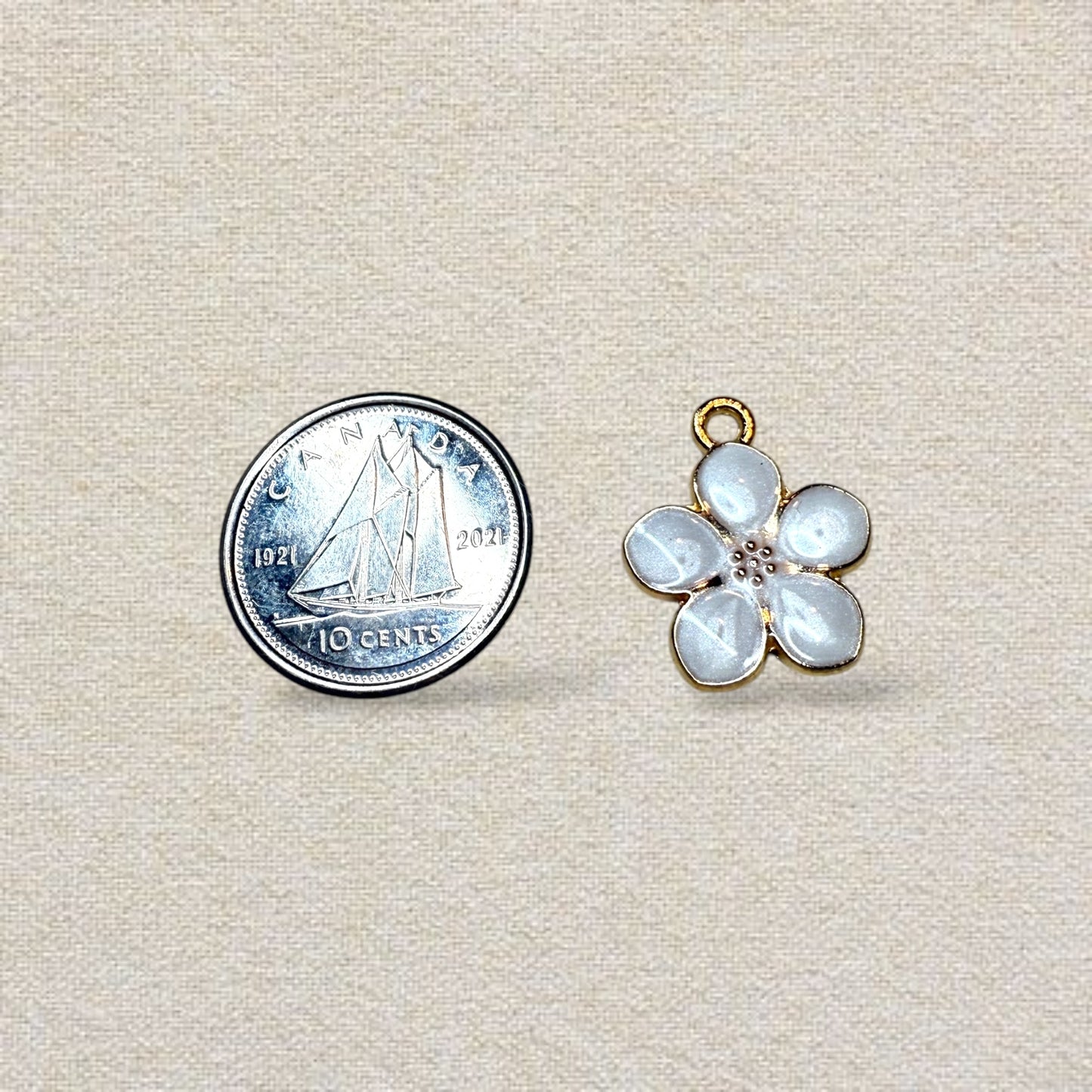 gold and white hawaiian flower charm