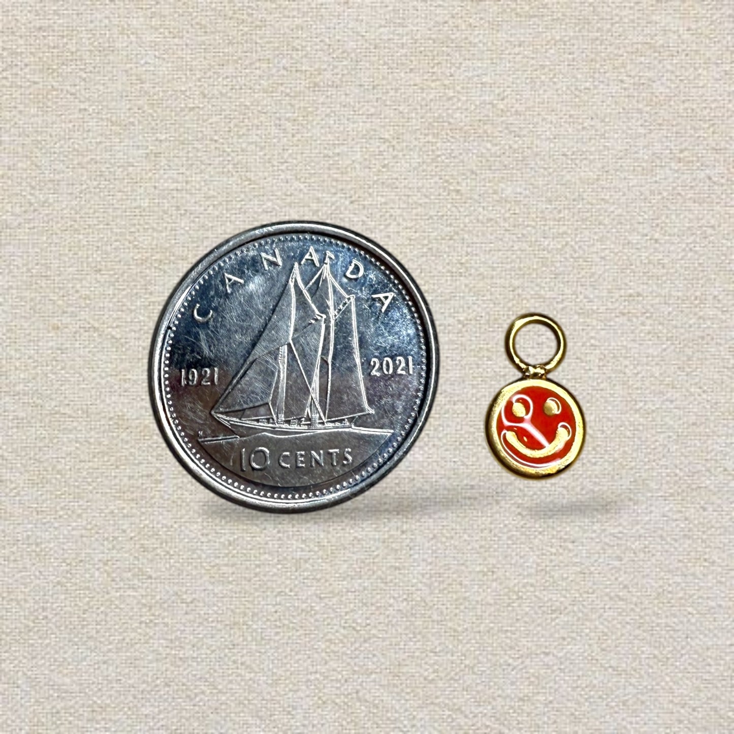 gold and green smiley face charm