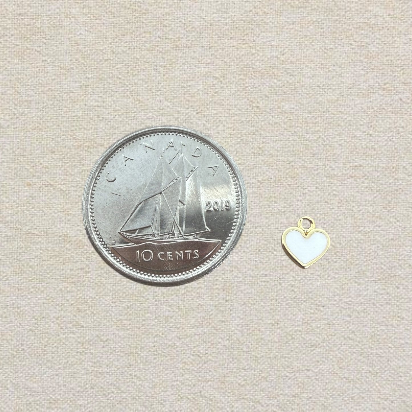 white and gold heart charm