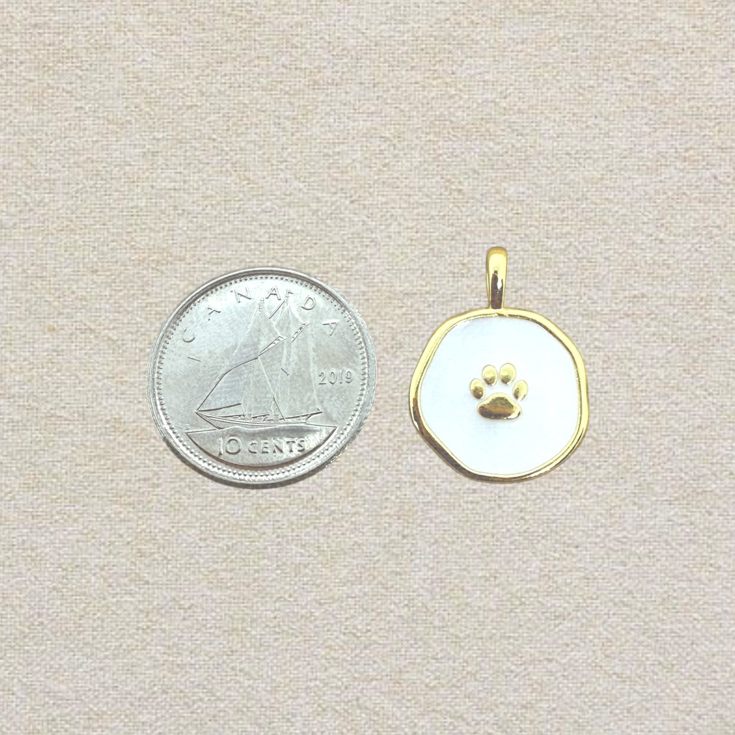 gold and white paw pendant