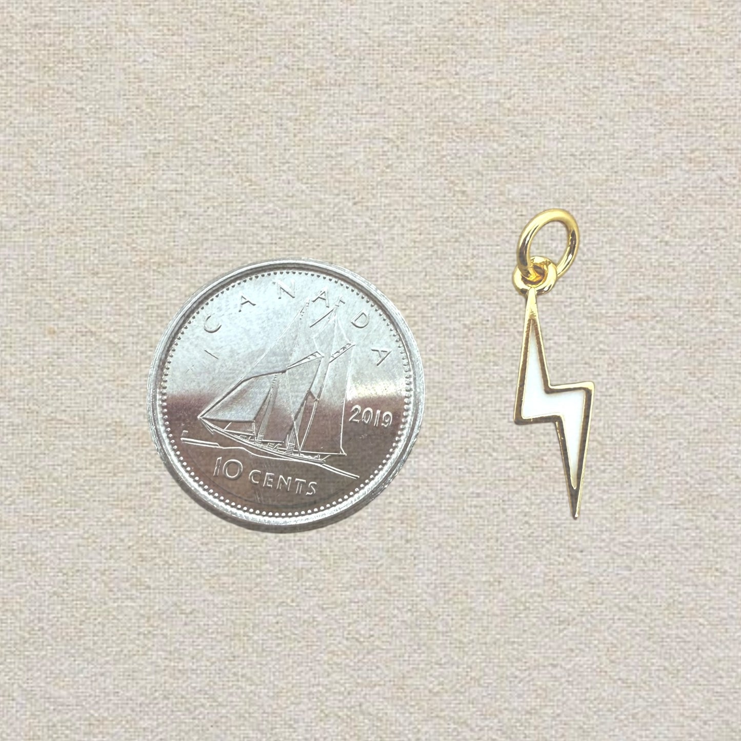 gold and white lightning bolt charm