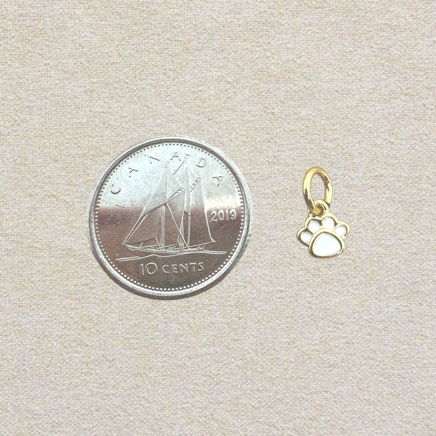 gold and white mini paw charm