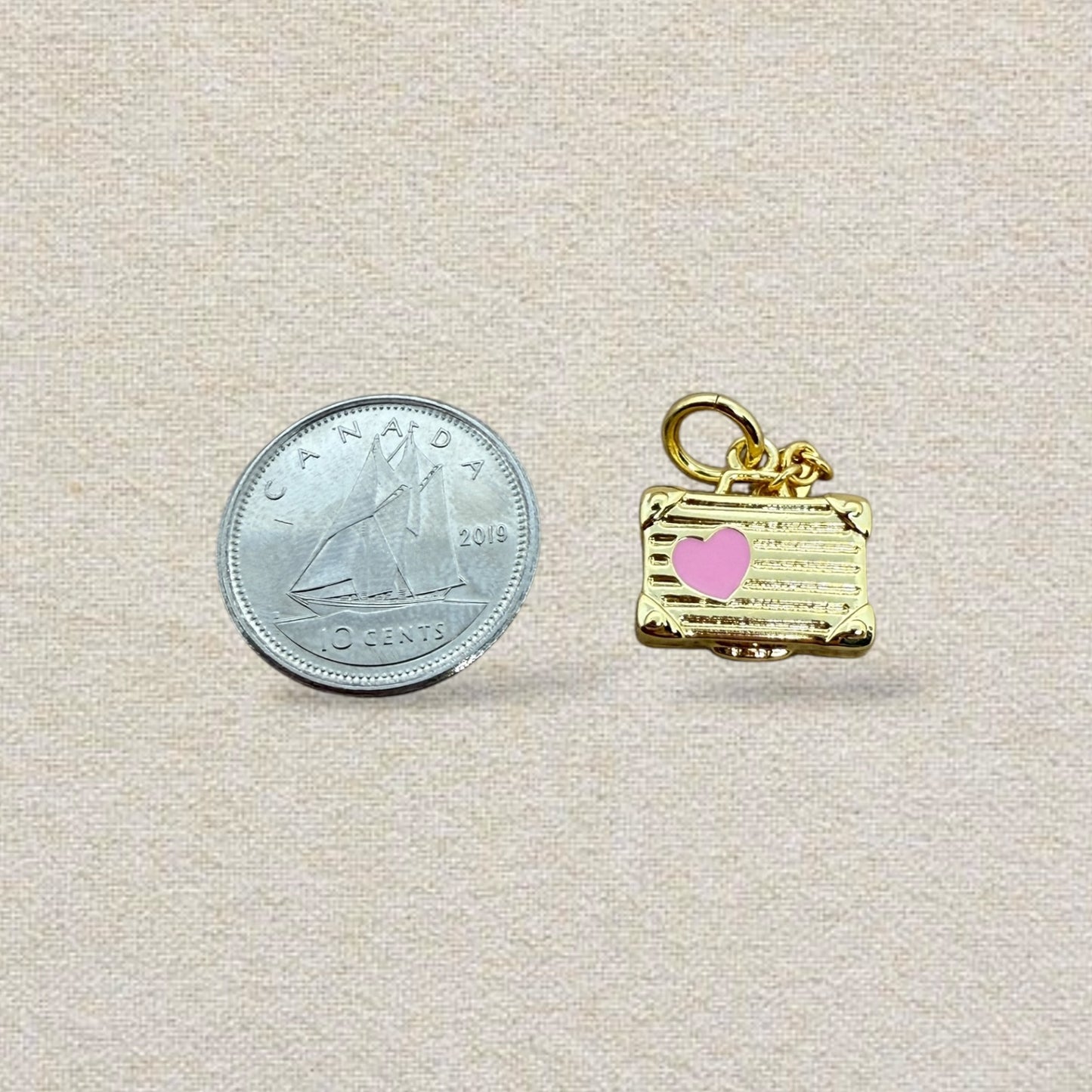 gold and pink suitcase charm