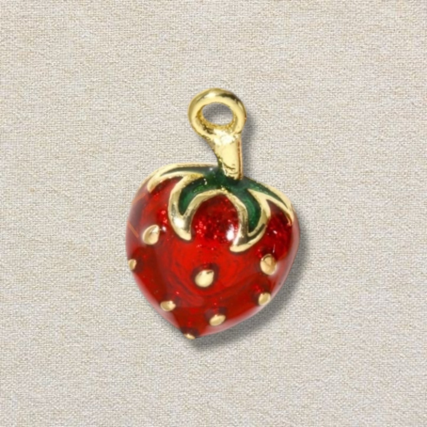 red, gold, and green strawberry charm