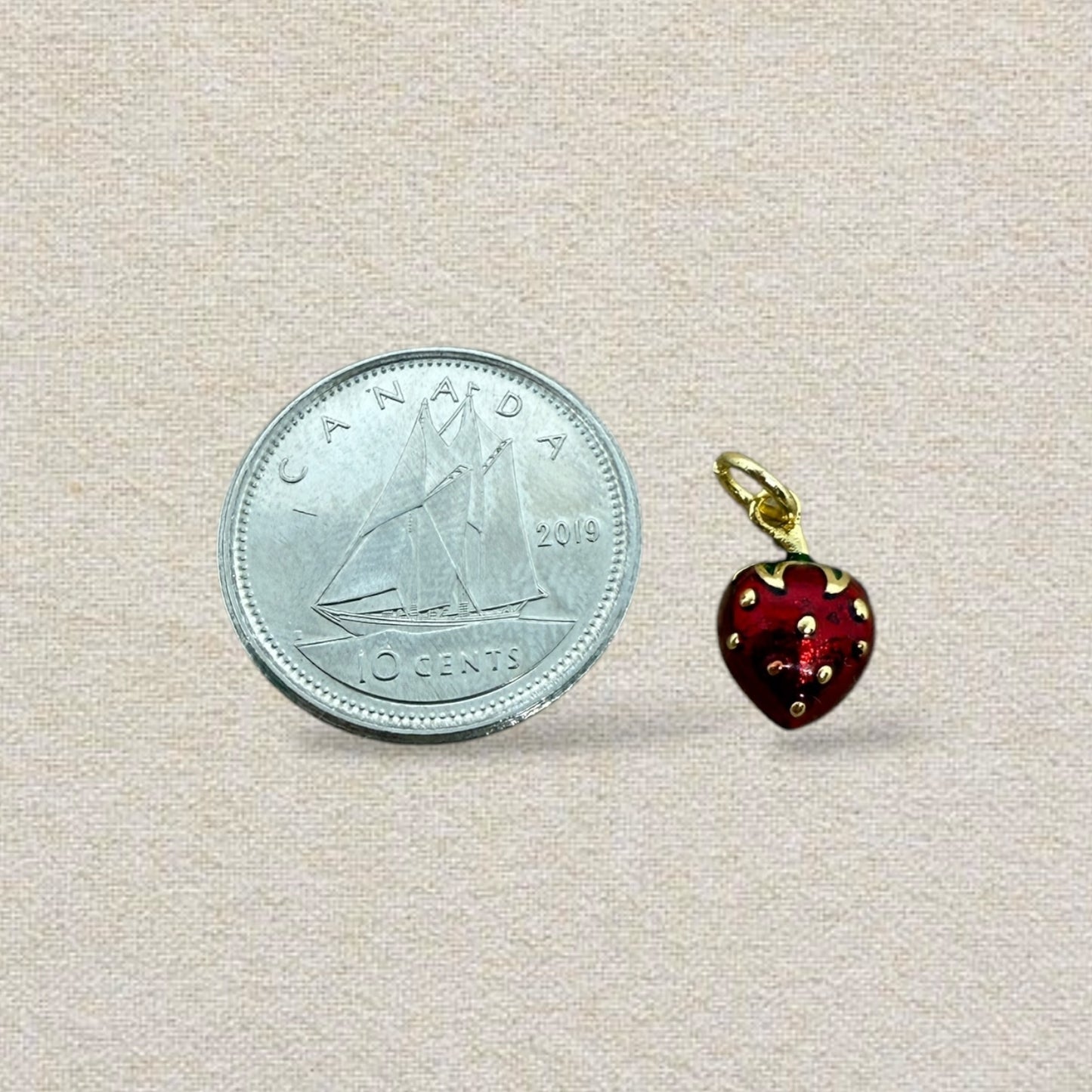 red, gold, and green strawberry charm