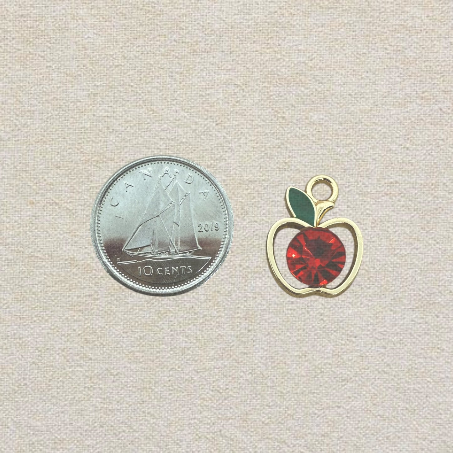 gold and red apple charm