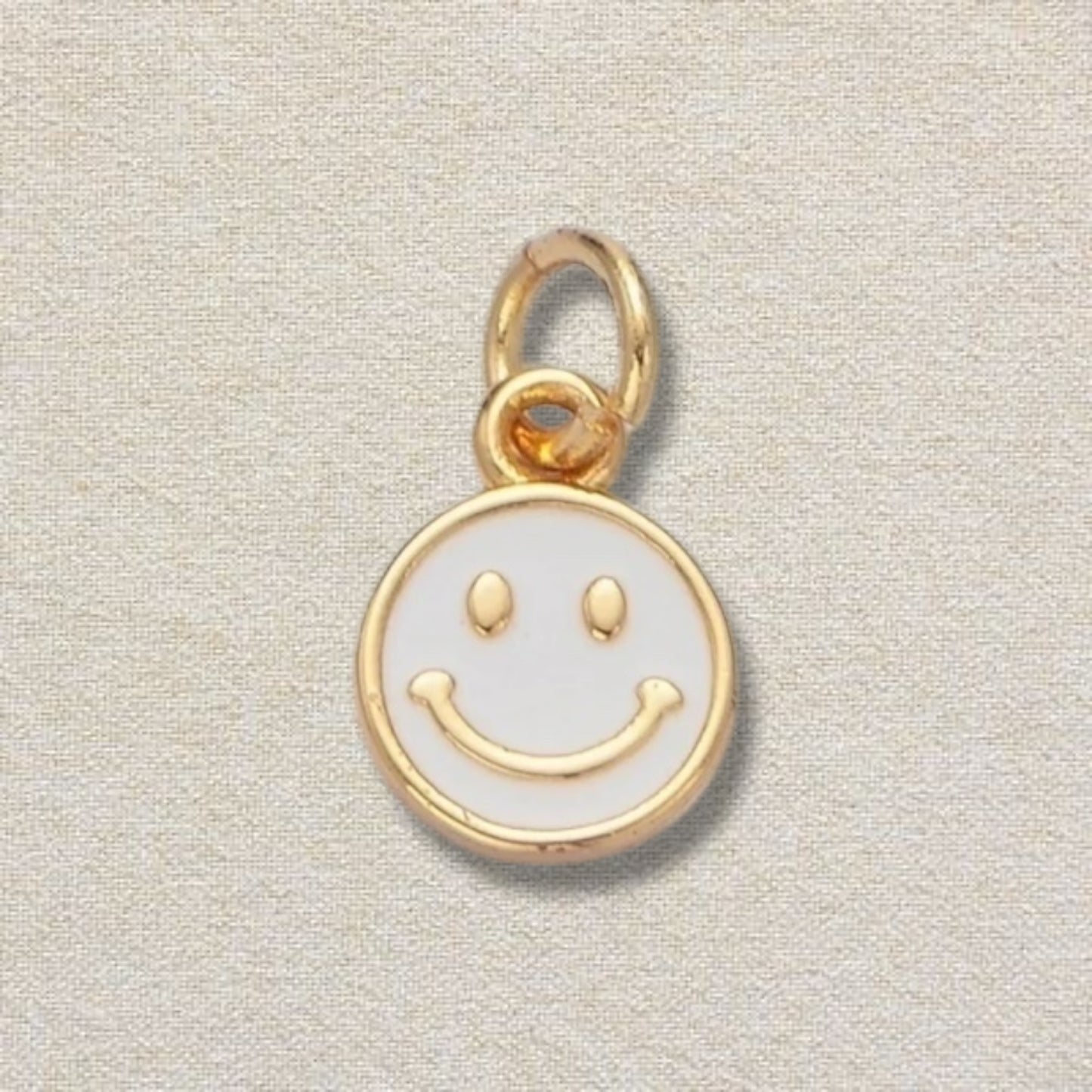 white and gold smiley charm