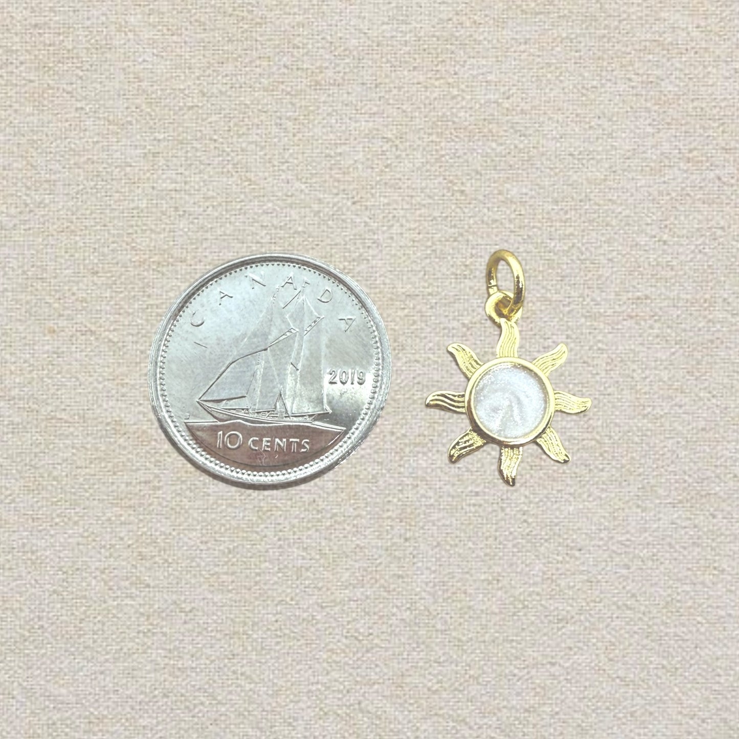 gold and pink sun charm