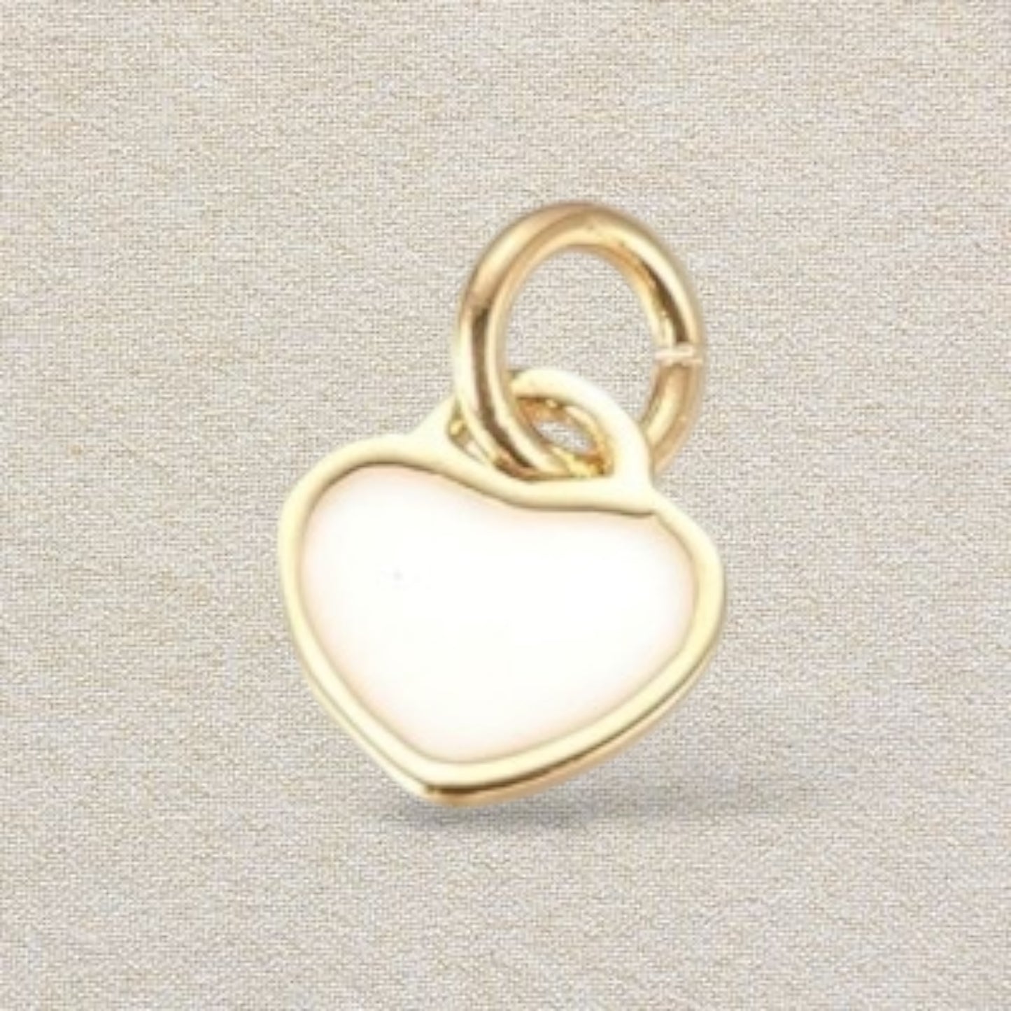 white and gold heart charm