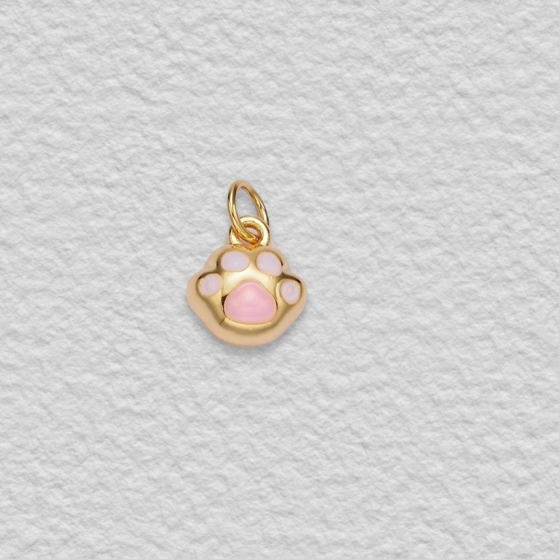 pink and gold paw charm
