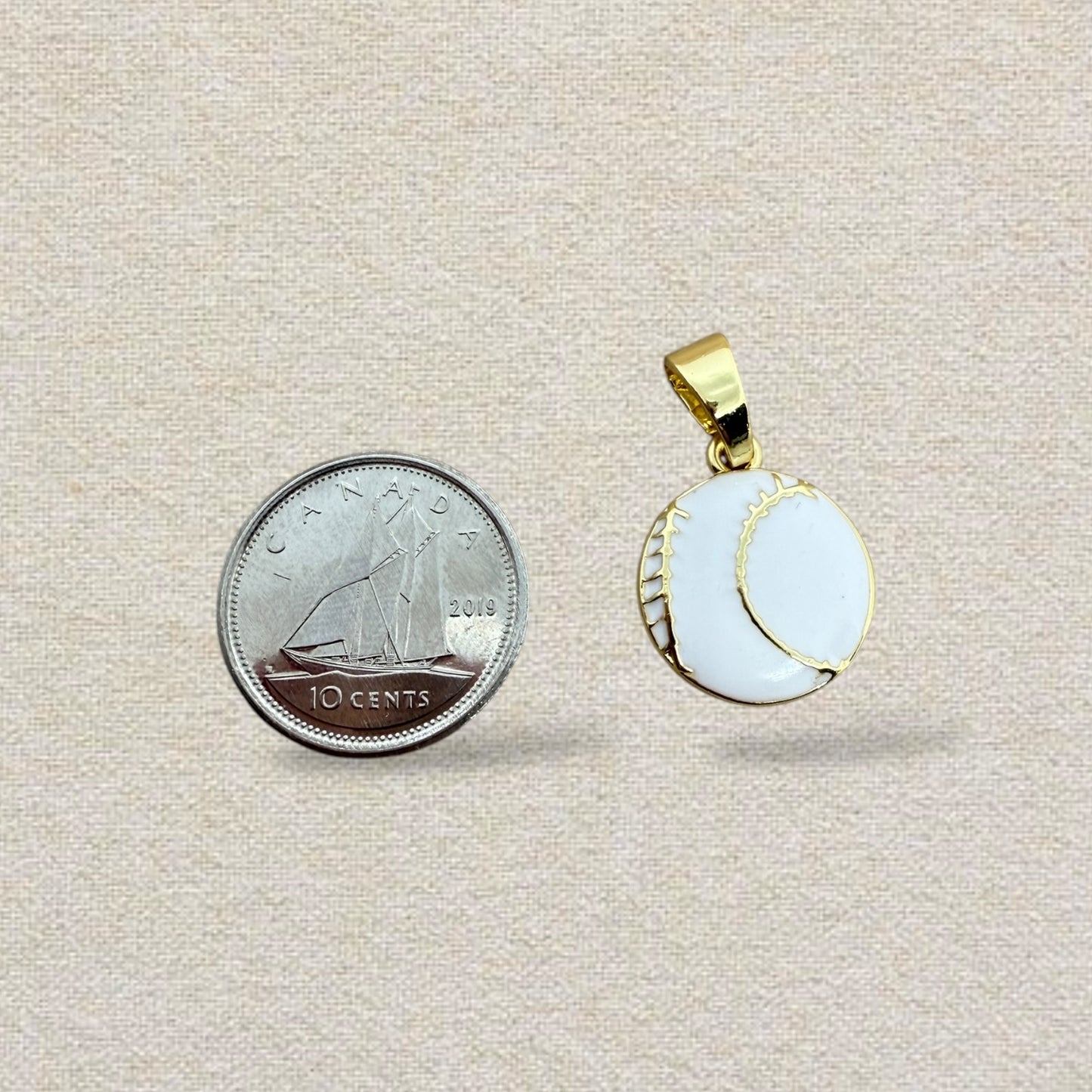 gold and white baseball charm