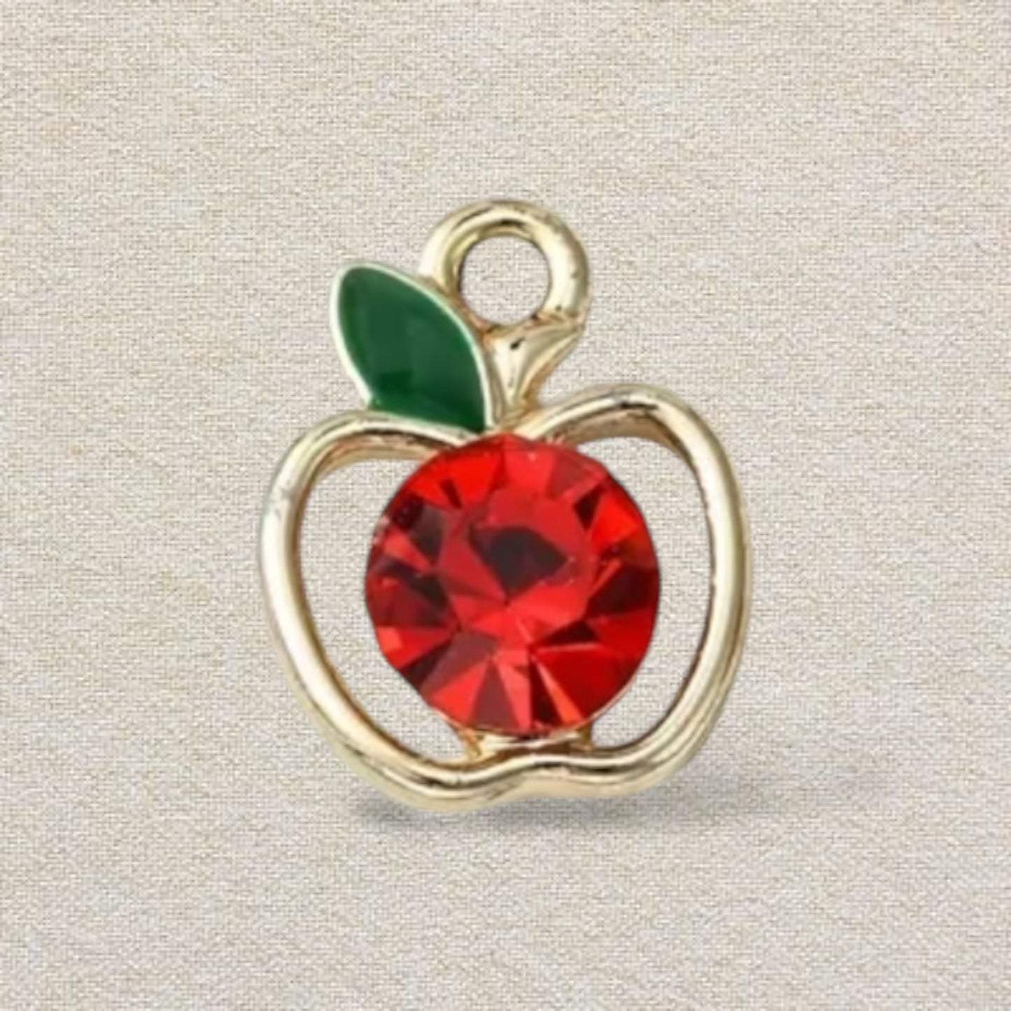 gold and red apple charm