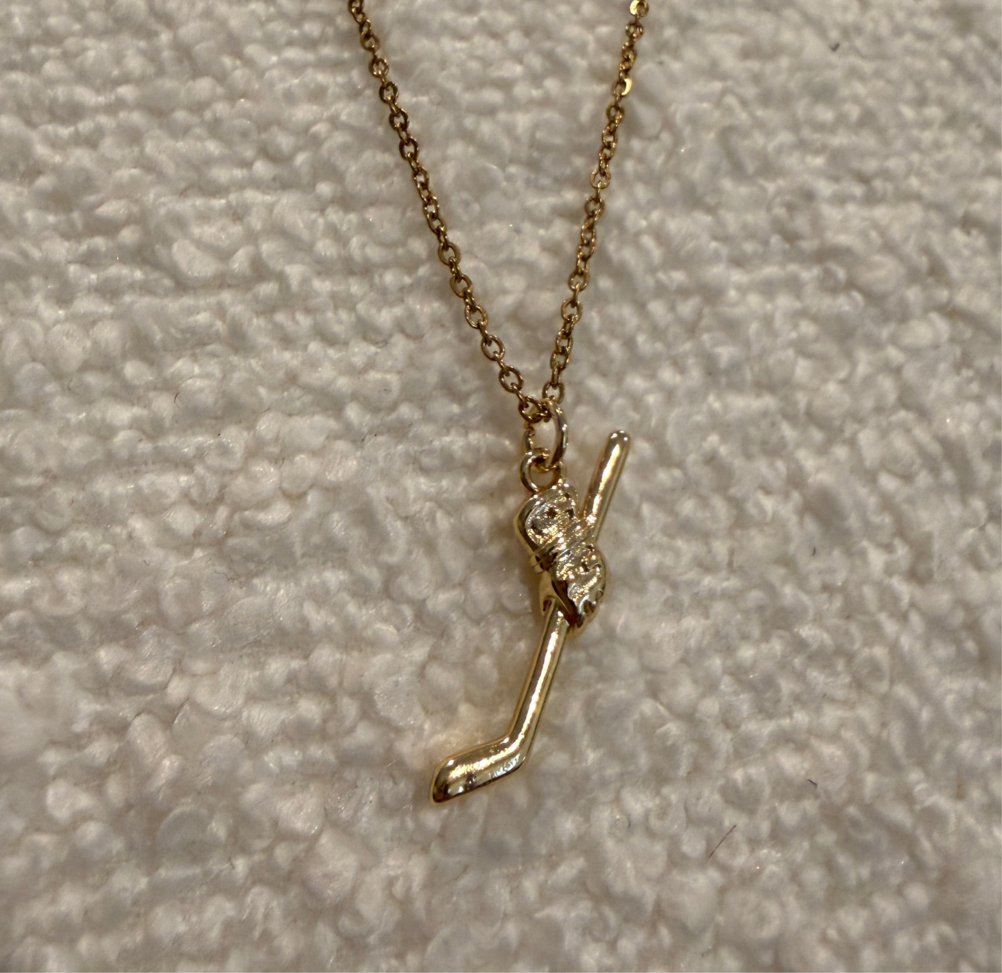 Gold hockey necklace