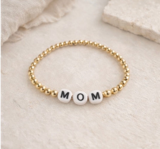 the mom bracelet in gold (white & black)