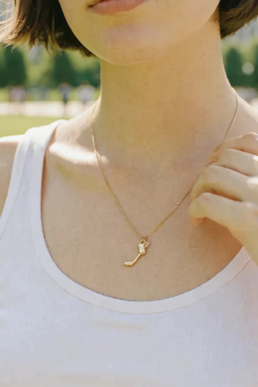 Gold hockey necklace