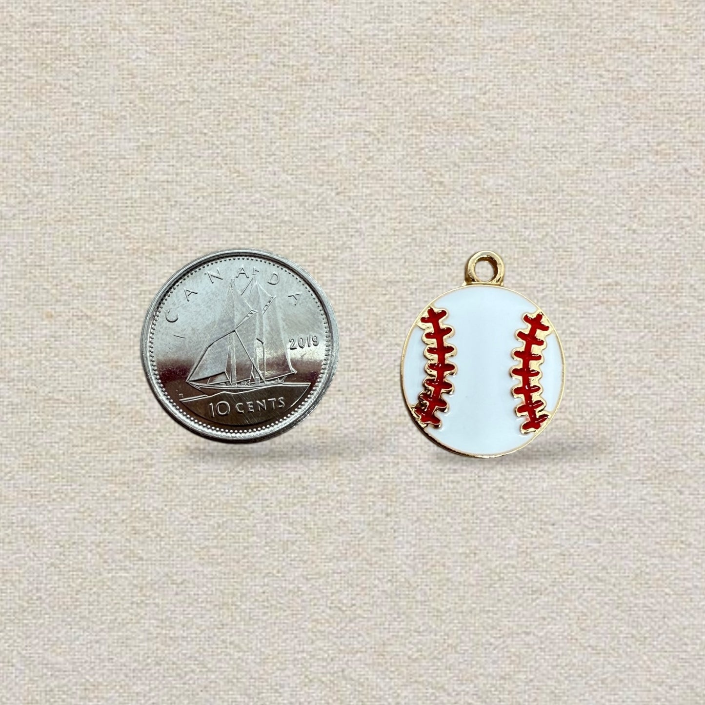 white and red baseball charm