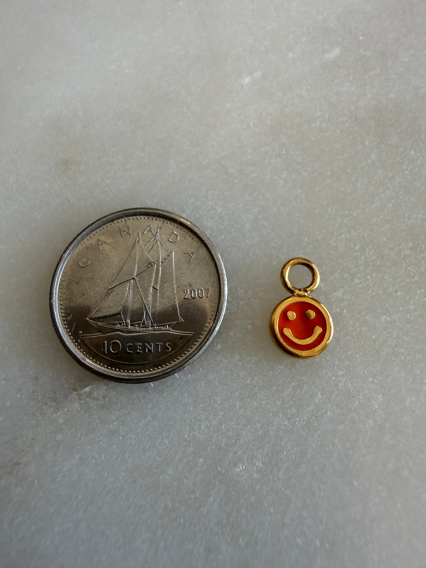 smiley face charm (pink)